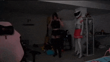 a woman in a cat costume is dancing in a dark room .