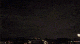 a fireworks display is going off in the night sky above a body of water