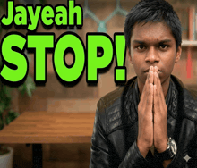 a man with his hands folded in front of a sign that says " jayeah stop "