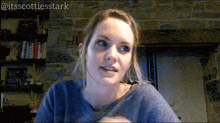 a woman sitting in front of a brick wall with the hashtag @itsscottiesstark on the bottom