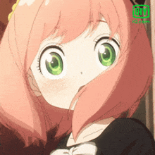 a girl with pink hair and green eyes is wearing a black dress .