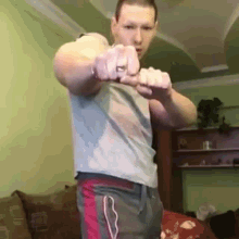 a man is pointing at the camera with his fist .