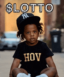 a young boy wearing a ny hat and a shirt that says hov