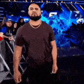 a man with a beard is standing in front of a sign that says s on it