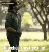 a man standing in a park with the words hitechu in his free time below him