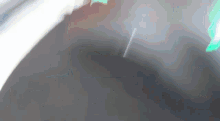 a green light is shining on a gray surface