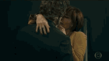 a man and a woman are kissing in a dark room .