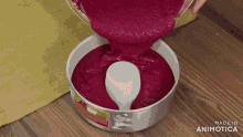 a cake batter is being poured into a pan with the words made in animotica visible