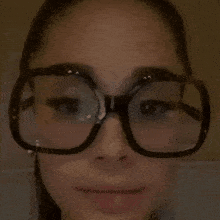 a close up of a woman wearing glasses