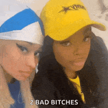two women wearing hats are posing for a picture .