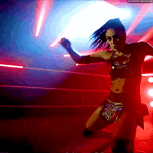 a woman is dancing in a dark room with a watermark that says ' thenextbigthing '