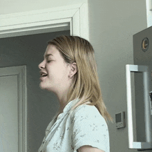 a woman stands in front of a lg refrigerator