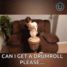 a man sitting on a couch with a duck on top of a drum that says can i get a drum roll please