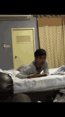a man laying on a bed in a room with a door