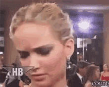 a close up of a woman 's face with the word hb on the bottom .