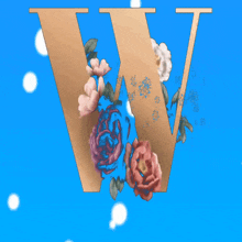 the letter w is surrounded by flowers and snowflakes on a blue background