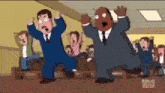 a group of cartoon characters are dancing in front of a crowd of people .
