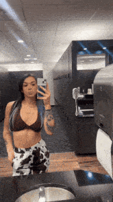 a woman taking a picture of herself in a bathroom mirror