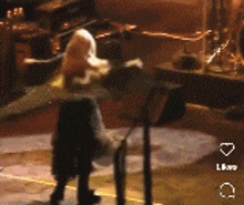 a blurred image of a person standing in front of a table with the word live on the bottom