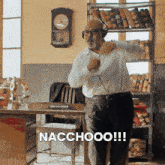 a man wearing headphones is dancing in an office with the words nacchooo written on the bottom