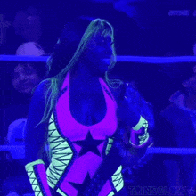 a woman in a glow in the dark outfit is standing in a ring