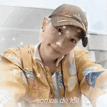 a young woman wearing a hat and a jacket is taking a selfie .