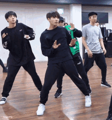 a group of young men are dancing in a room with the name sugawxy on the bottom