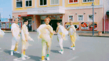 a group of people are dancing in front of an ocean palace