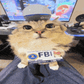 a cat wearing a fbi badge sitting on a person 's lap