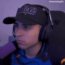 a man wearing headphones and a hat that says mira
