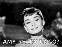 a black and white photo of audrey hepburn with the words amy ready to go