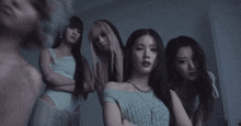 a group of women are standing in a dark room