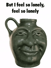 a statue of a man 's face with the words but i feel so lonely feel so lonely