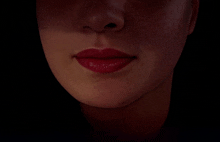 a close up of a woman 's mouth with red lips