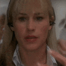 a close up of a woman 's face with earbuds on