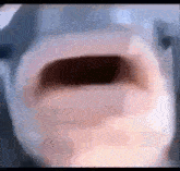 a close up of a person 's face with their mouth open .