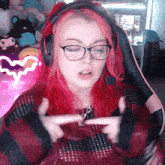 a girl with red hair wearing headphones and glasses
