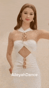 a woman in a white dress with alleyah dance written on the bottom right