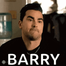 a man is making a funny face and the word barry is on the screen .