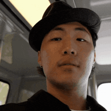 a close up of a man wearing a hat