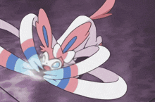 a pink and white cartoon rabbit is laying on a purple surface .