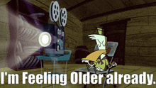 a cartoon of a man sitting in front of a movie projector with the words i 'm feeling older already