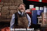 a man in an apron says any questions boys in front of a stone wall