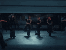 a group of women are standing next to each other in a dark area