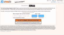 a screenshot of omegle.com shows a man pointing at something
