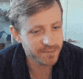 a man with a beard is wearing a blue robe