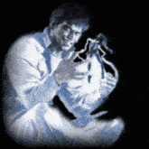 a man in a white shirt is holding a toy figure