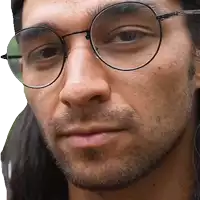 a close up of a man wearing round glasses