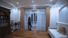 a woman is dancing in a living room with the words made in animotica on the bottom