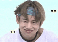 a close up of a person wearing a headband and making a funny face .